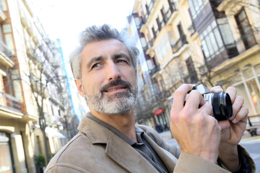 Photographer taking pictures in city street
