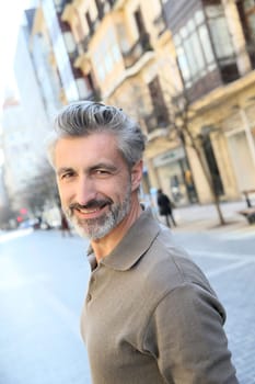 Handsome mature man standing in the street