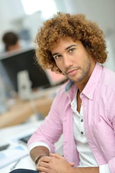 Young man in office working on desktop computer