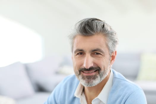 Portrait of handsome mature man with grey hair