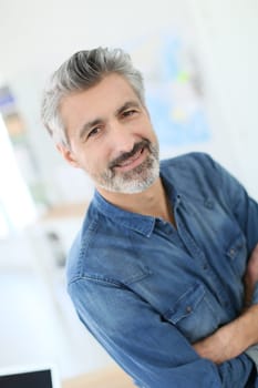 Portrait of smiling mature teacher in class