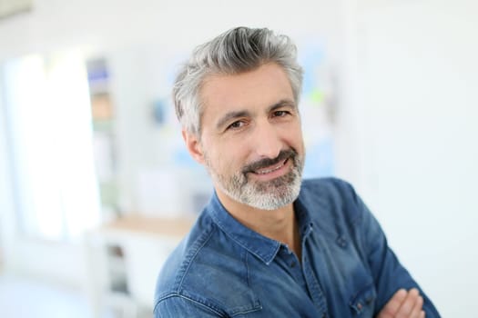 Portrait of smiling mature teacher in class