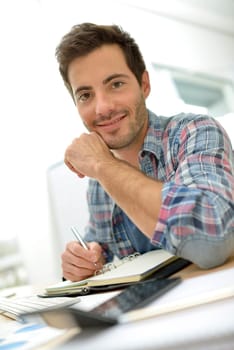 Smiling office worker sitting at desk