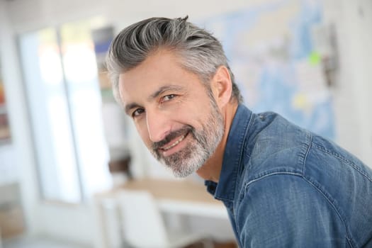Portrait of smiling mature teacher in class