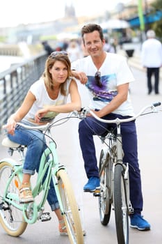 Cheerful couple riding bikes in Bordeaux