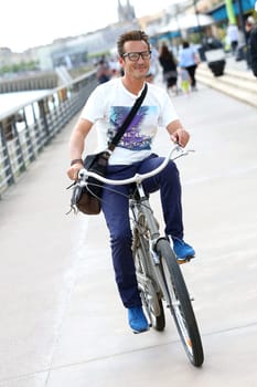 Man riding bicycle in Bordeaux