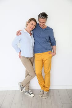 Cheerful mature couple on white background