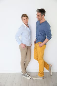 Cheerful mature couple on white background