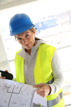 Woman engineer on building site checking construction