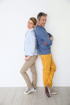 Cheerful mature couple on white background