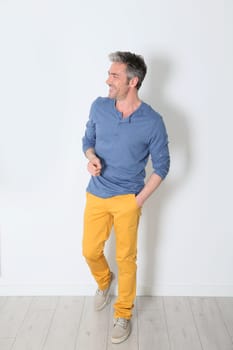 Cheerful trendy mature man on white backgound