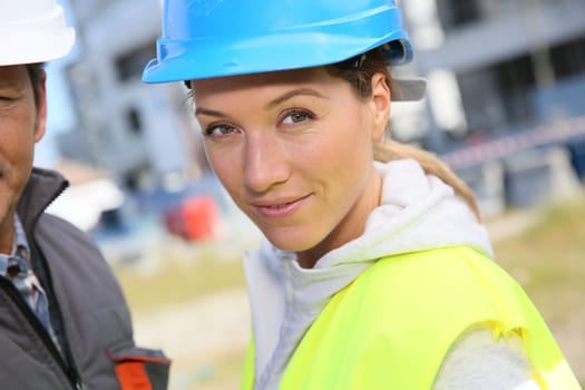 Portrait of woman engineer working on building site