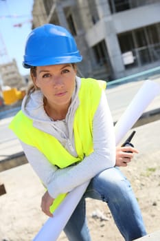 Portrait of woman engineer working on building site