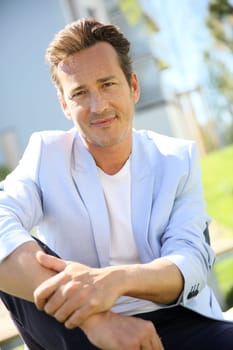Handsome 40-year-old man relaxing in park