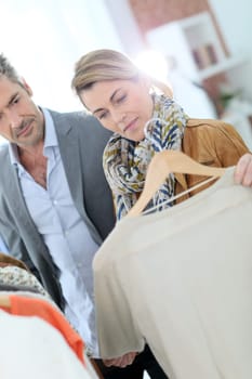 Mature couple shopping in clothing store