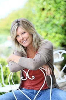Portrait of smiling mature blond woman in garden