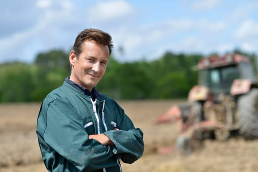 Portrait of smiling farmer in cultivated land