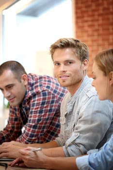 Portrait of smiling student gathering with friends