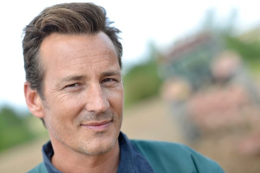 Portrait of smiling farmer in cultivated land