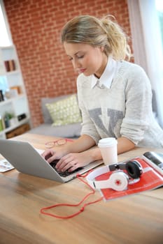 College girl studying on laptop