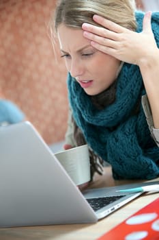 Young woman working at home and being sick