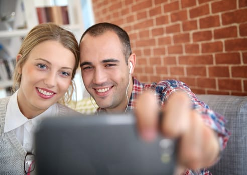 Friends taking picture of themselves with smartphone