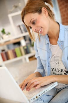 Young woman using laptop computer at home