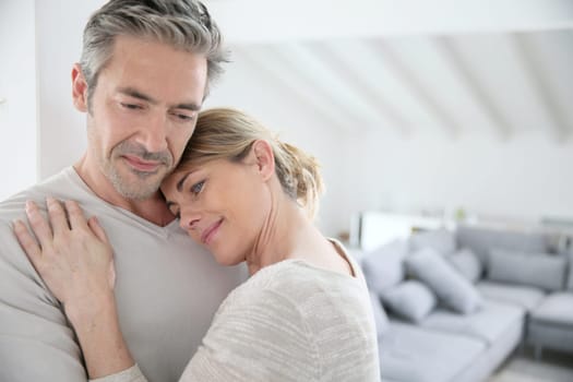 Mature man embracing wife and feeling good