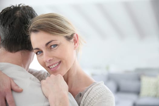 Portrait of mature woman embracing her husband