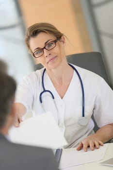 Doctor meeting with patient in hospital office