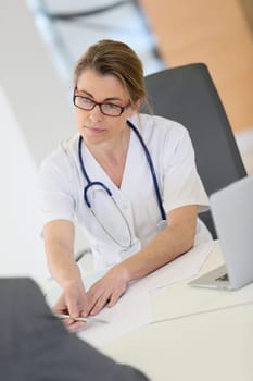 Doctor meeting with patient in hospital office