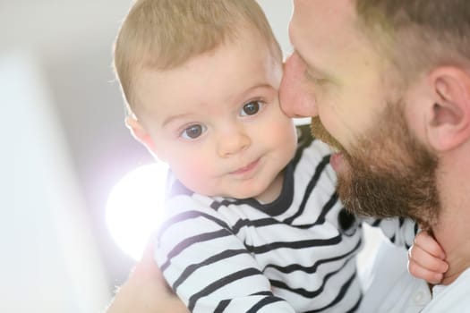 Portrait of daddy embracing baby boy