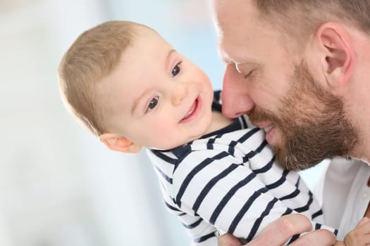 Portrait of daddy embracing baby boy