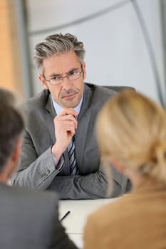 Consultant listening to clients in meeting