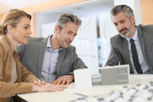 Mature couple meeting architect for construction project