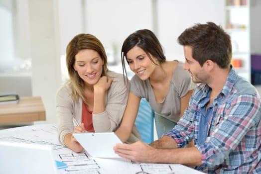 Workteam of architects meeting in office
