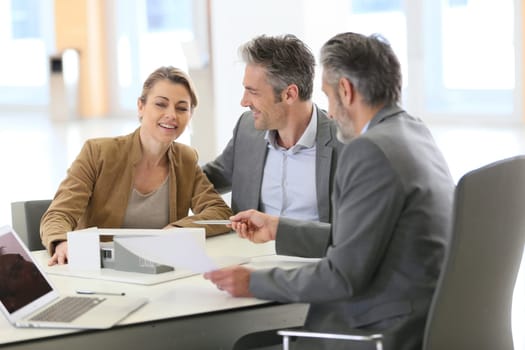 Mature couple meeting architect for construction project