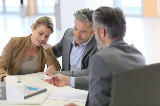 Mature couple meeting architect for construction project