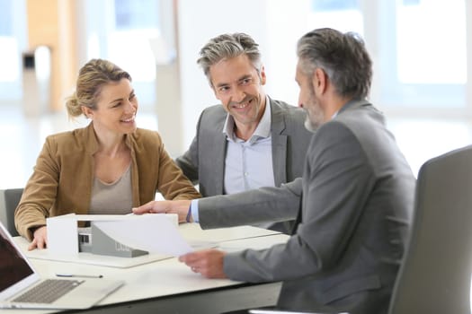 Mature couple meeting architect for construction project
