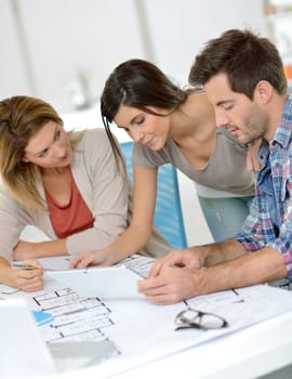 Workteam of architects meeting in office