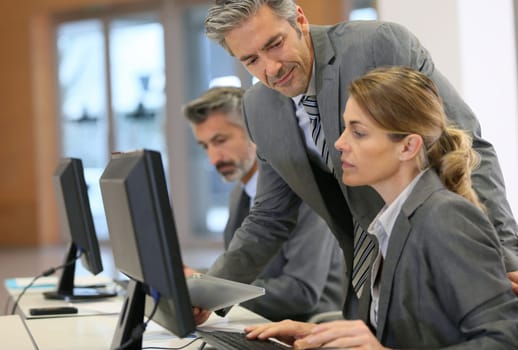 Business people working in office on desktop computer