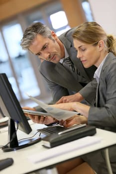 Business people working in office on desktop computer