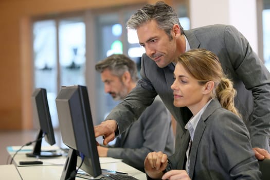 Business people working in office on desktop computer