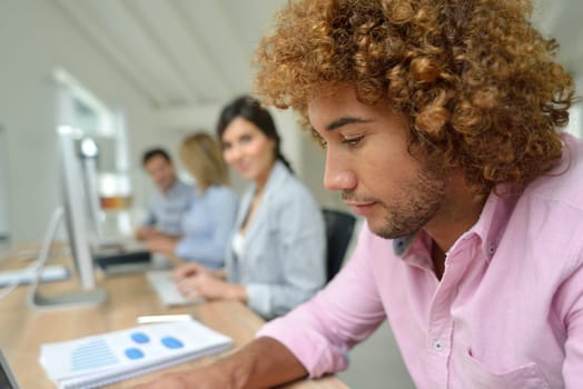 Young businessman in office working on laptop