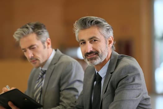 Portrait of mature businessman in a work meeting