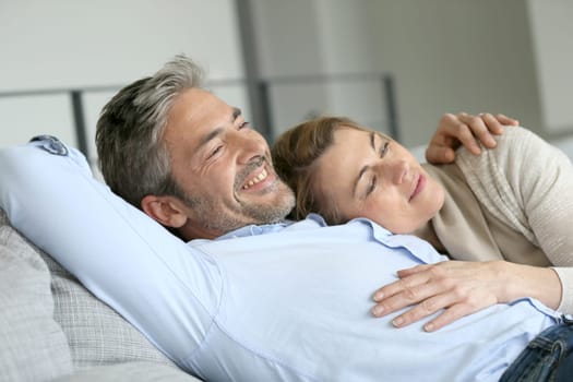 Mature couple relaxing in sofa, peaceful scene