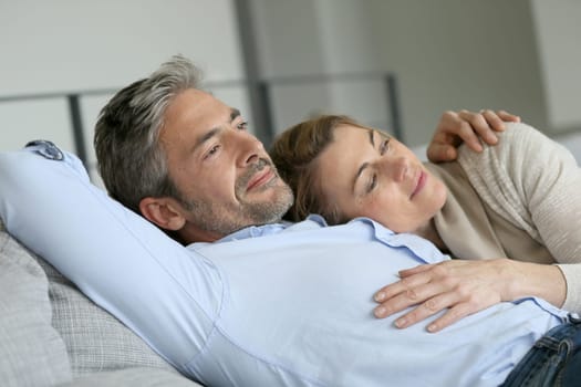 Mature couple relaxing in sofa, peaceful scene