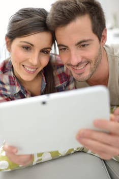 Couple at home websurfing on internet