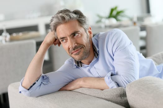 Portrait of mature man relaxing in sofa