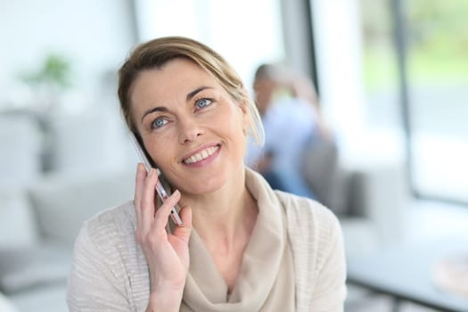 Portrait of mature blond woman talking on phone